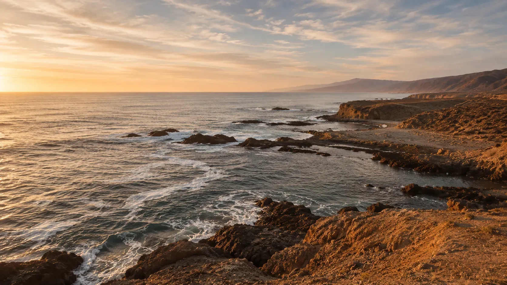 Amanecer sobre la costa, el sol bajo tocando el agua